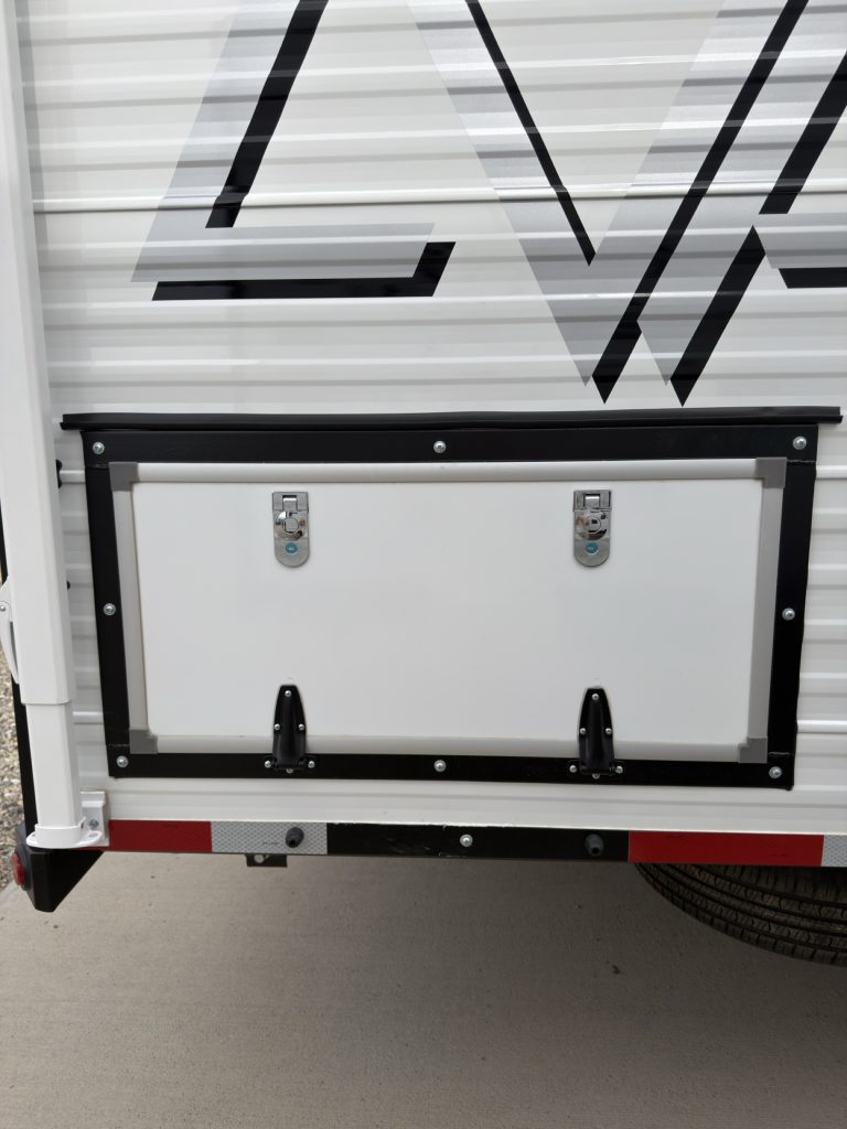 Closed dual-seal keyed exterior storage hatch.