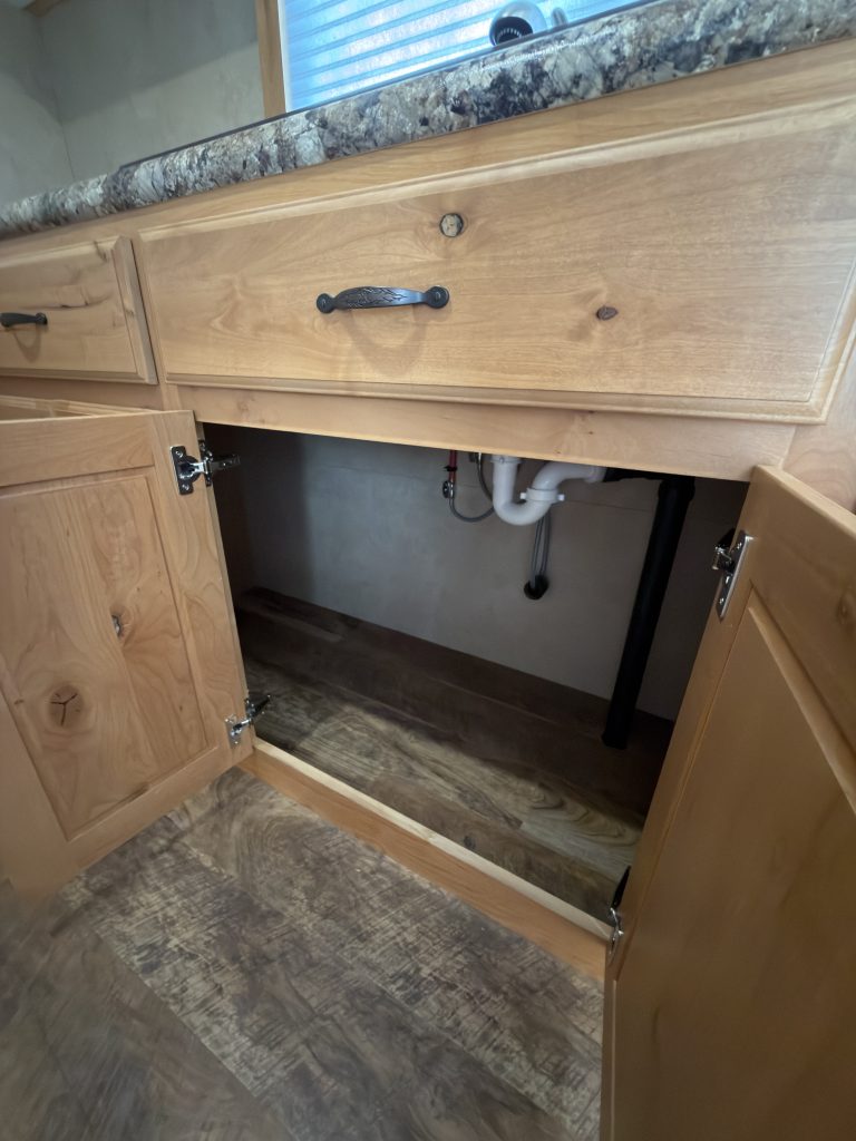Detail view of Open Storage Below Kitchen Sink in the Schrauth Camp.