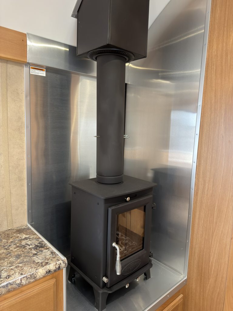 Wood-burning stove and fire backer in the Schrauth Camp