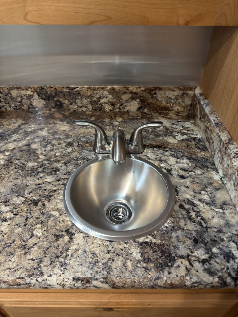 Stainless steel bathroom sink and countertop