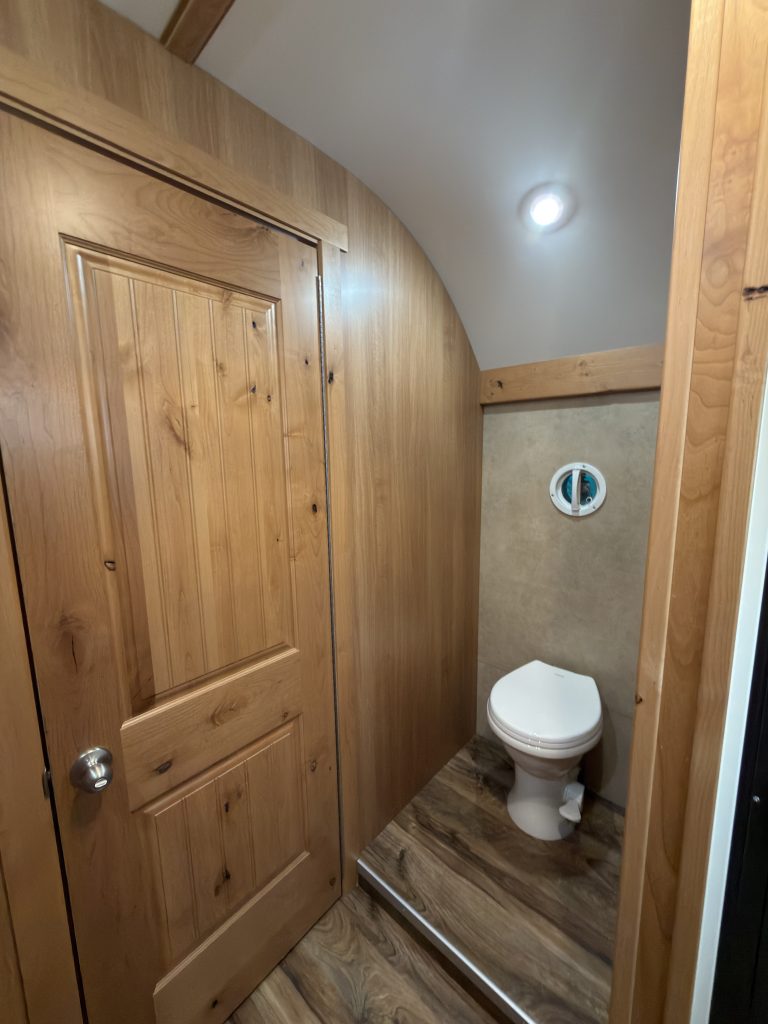 Schrauth Camp bathroom with hardwood door and toilet