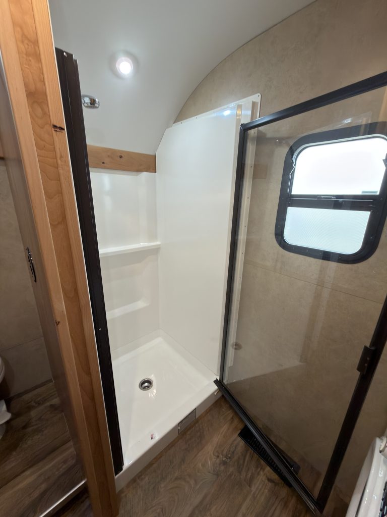 Glass shower door in the Schrauth Camp bathroom