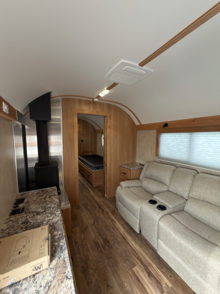 Schrauth Camp living room with recliner and wood stove