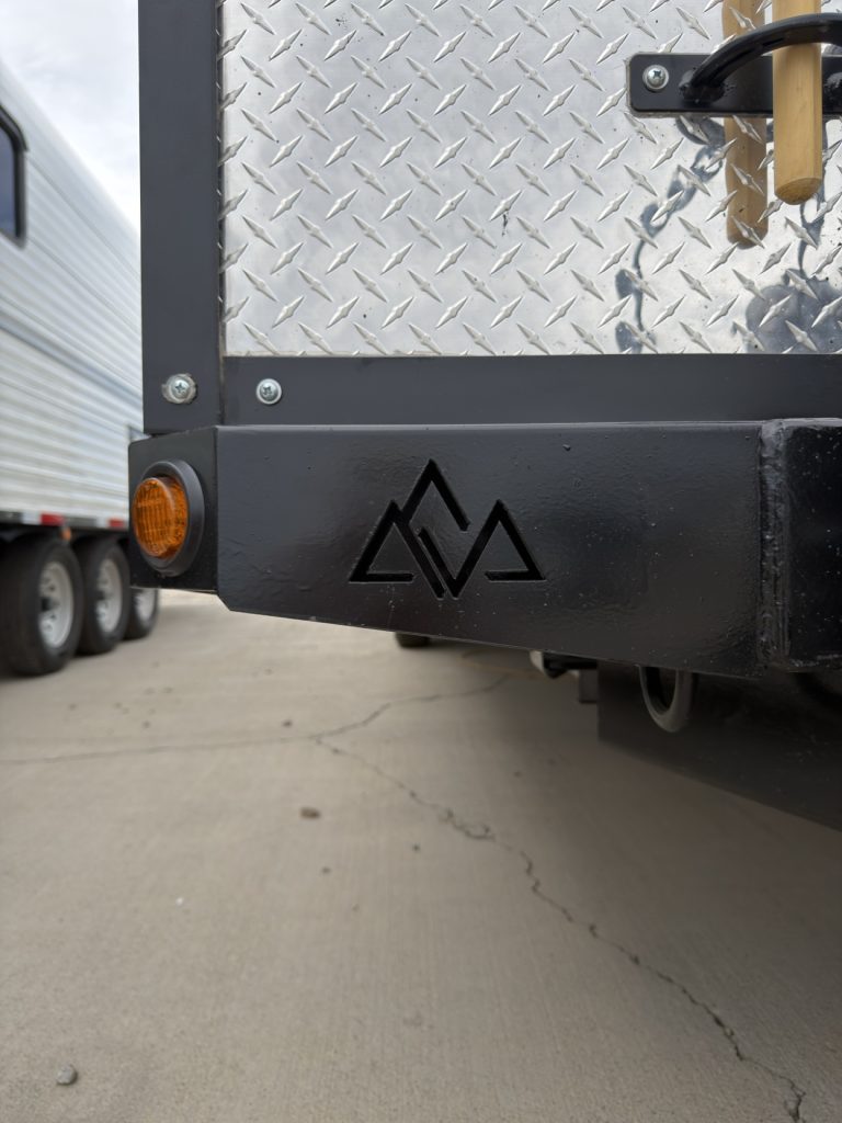 Black front frame with Peak Outdoors mountain logo and amber marker light.