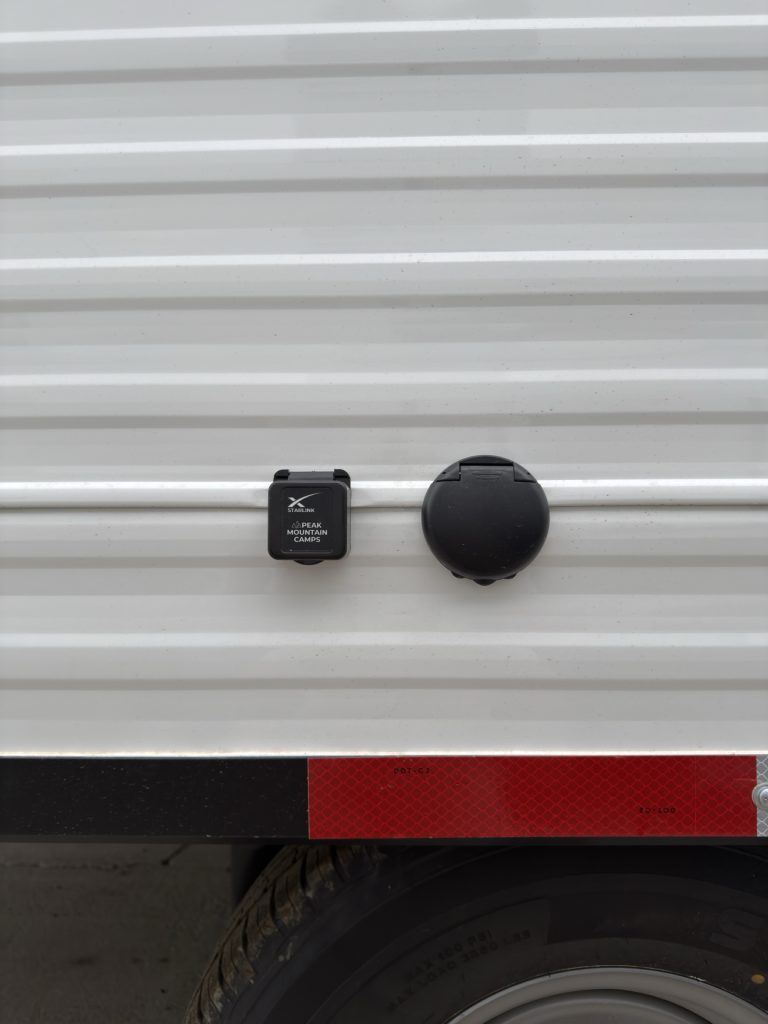 Ethernet jack and round exterior utility port above the wheel.