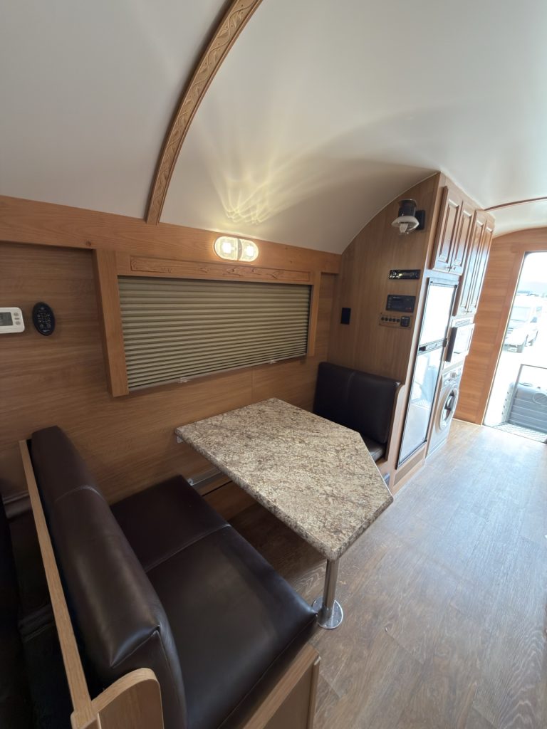 Dinette seating beneath a window shade.