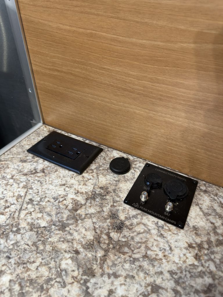 AC and DC power outlets along the granite-pattern entertainment countertop.