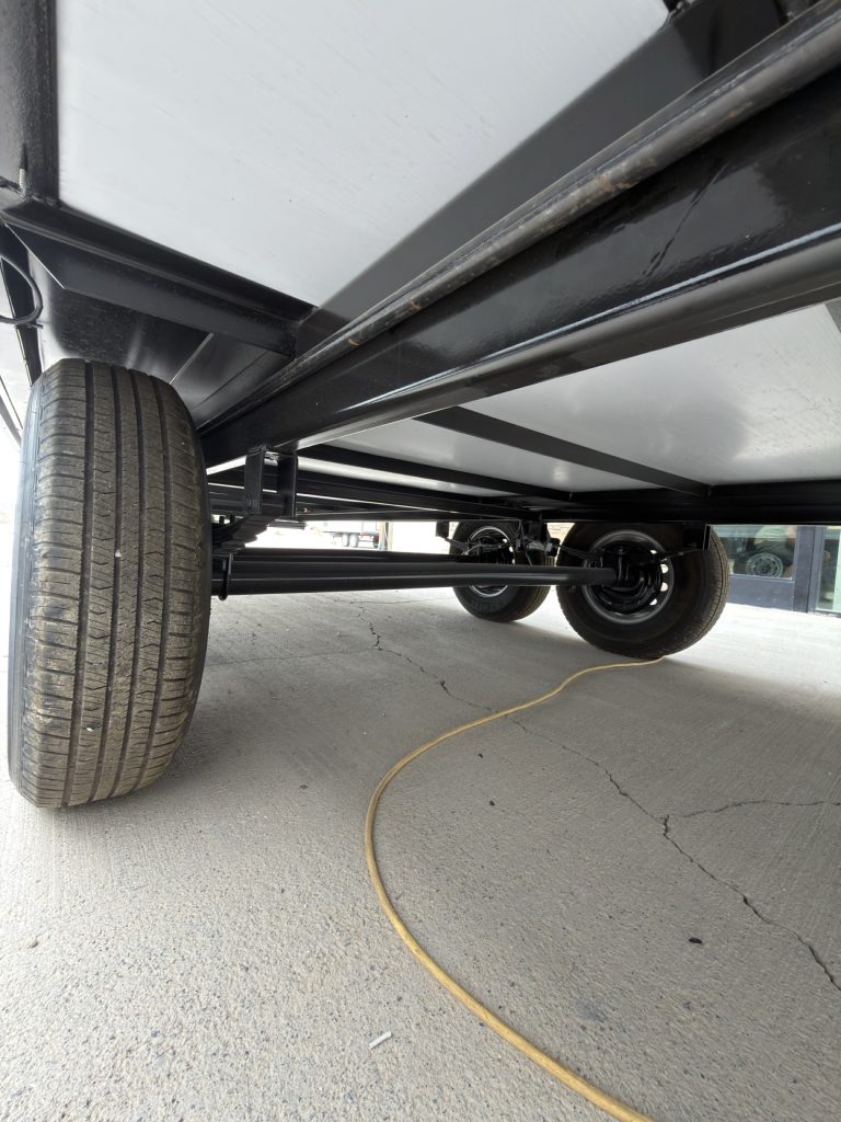 Leaf-spring suspension and axle viewed beneath the trailer.