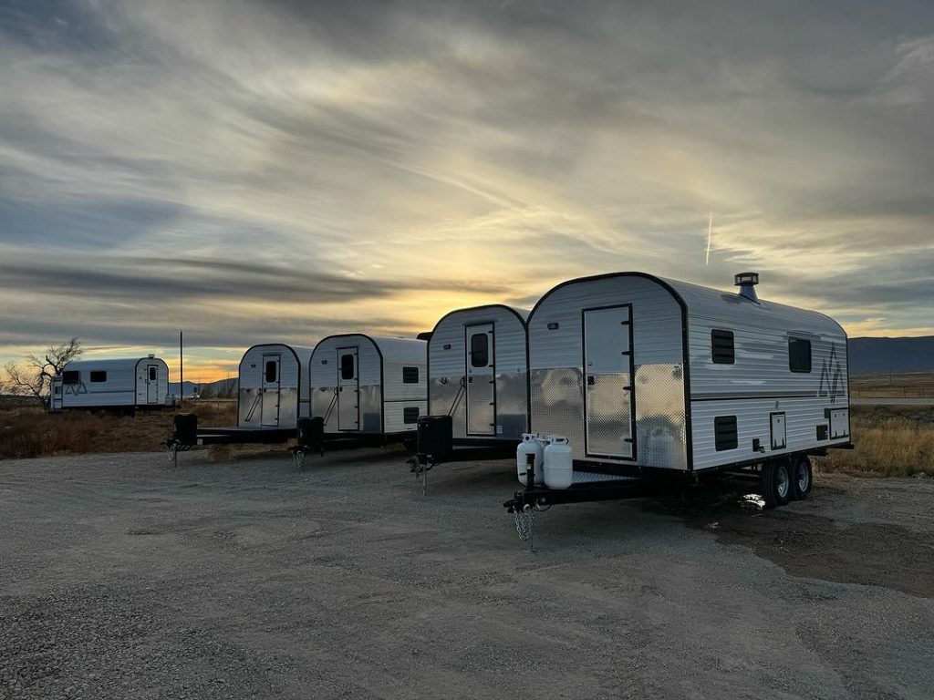Several custom Peak camp trailers lined up together at the build yard