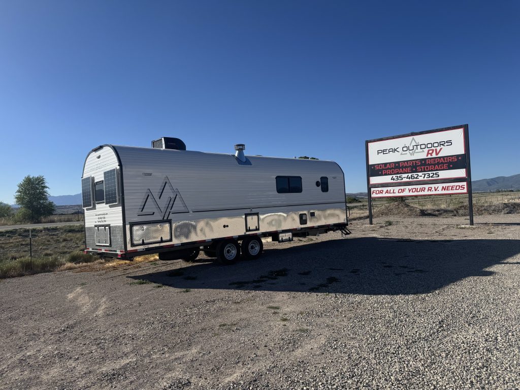 Peak Camp Beside the Peak Outdoors Sign