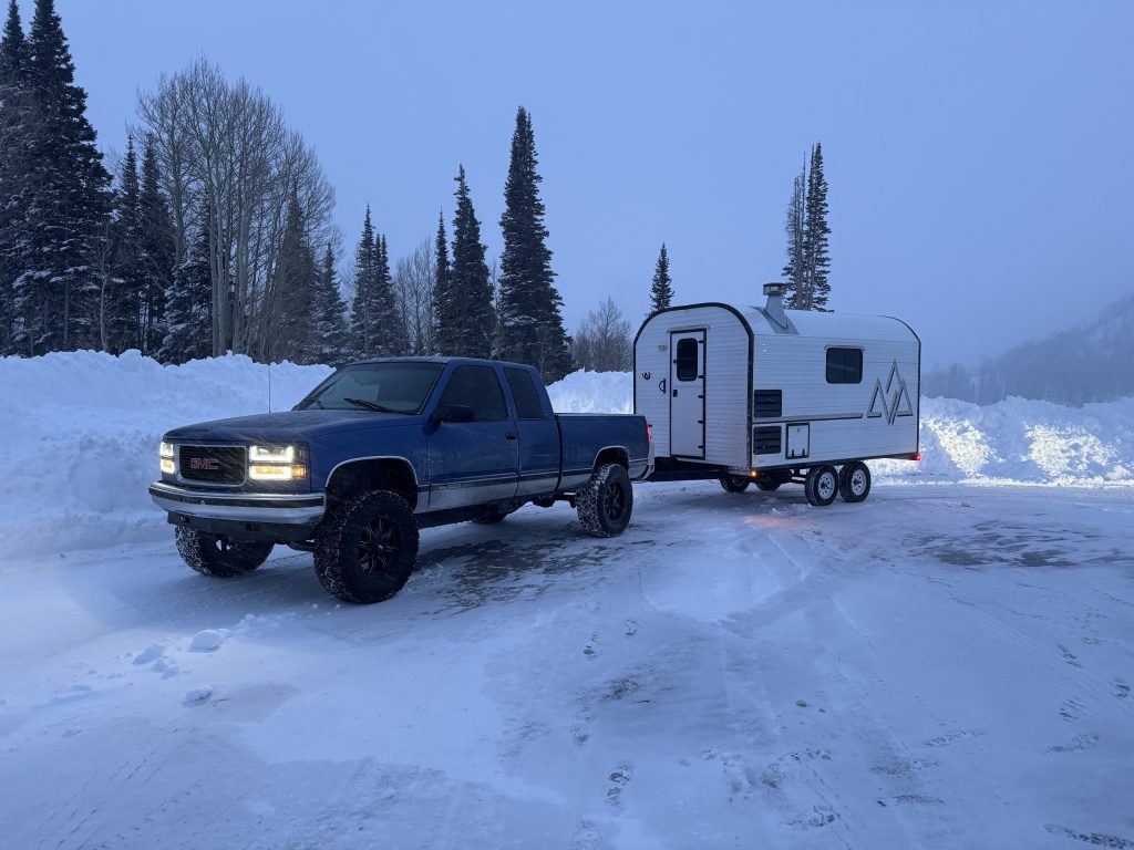 Peak Camp in a Snowy Mountain Clearing