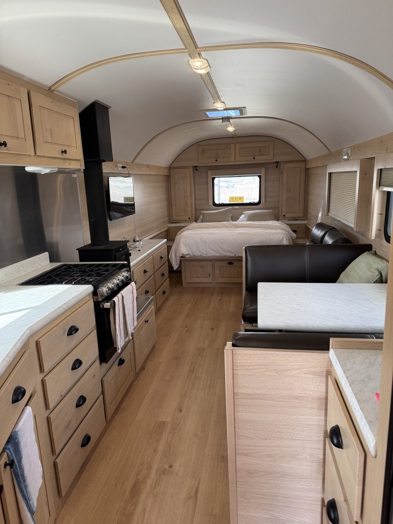 Peak Camp Interior With Wood Stove and Bedroom
