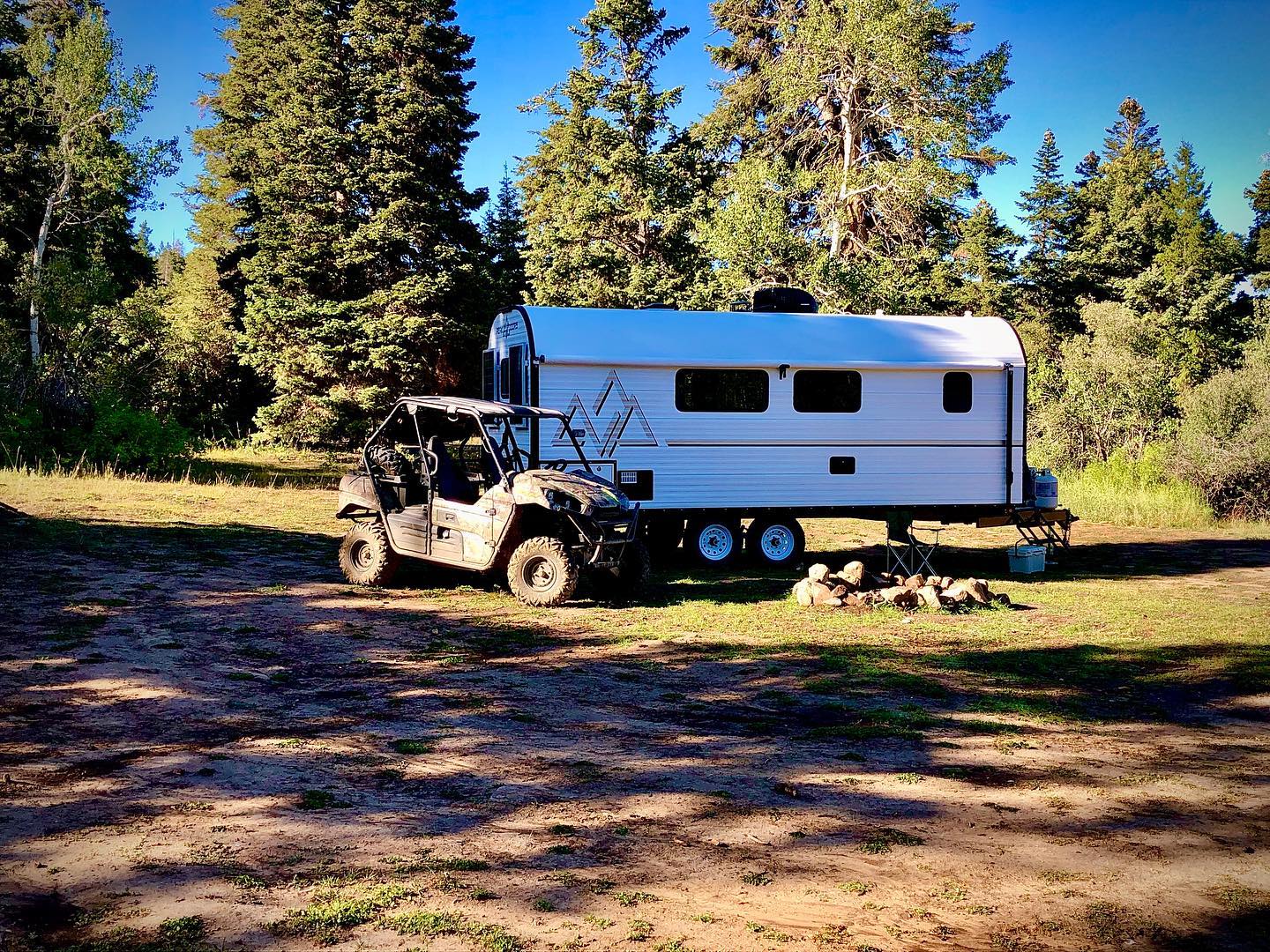 Peak camping trailer at a dispersed forest campsite.