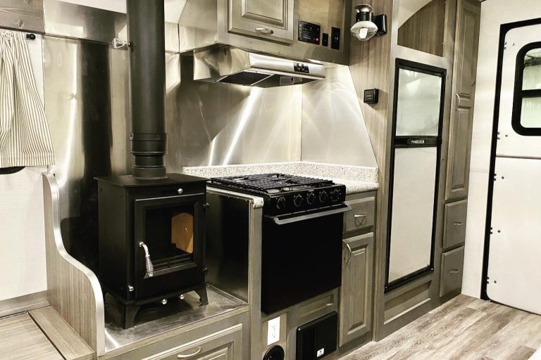 Refrigerator installed beside the kitchen inside a Peak Mountain Camp