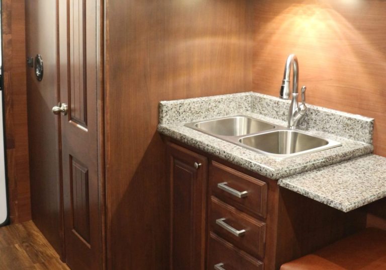 Kitchen sink and faucet inside a Peak camp trailer
