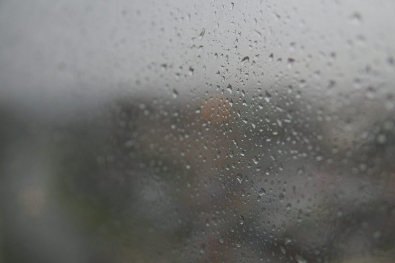 Water droplets and condensation covering a fogged RV window