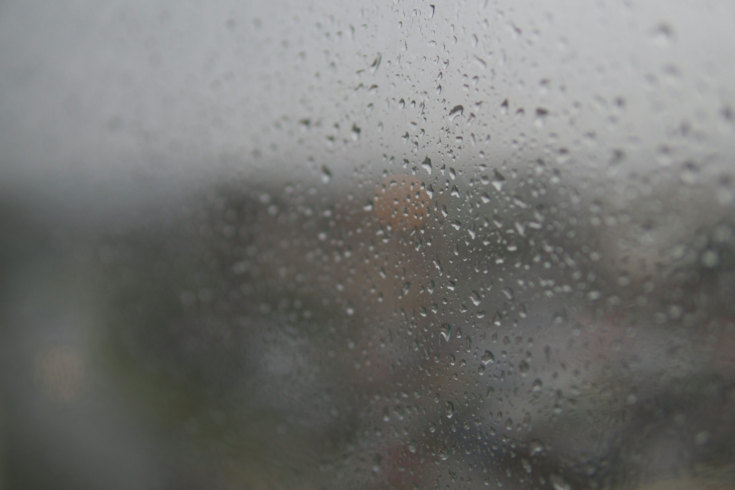 Water droplets and condensation covering a fogged RV window