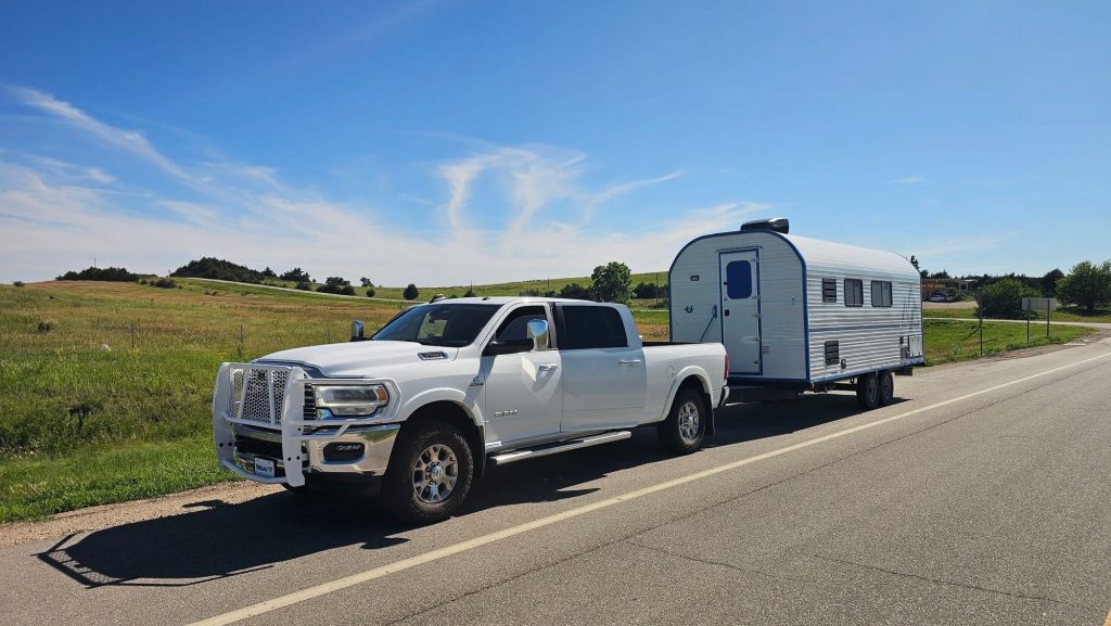 Truck Towing a Peak Camp on the Road