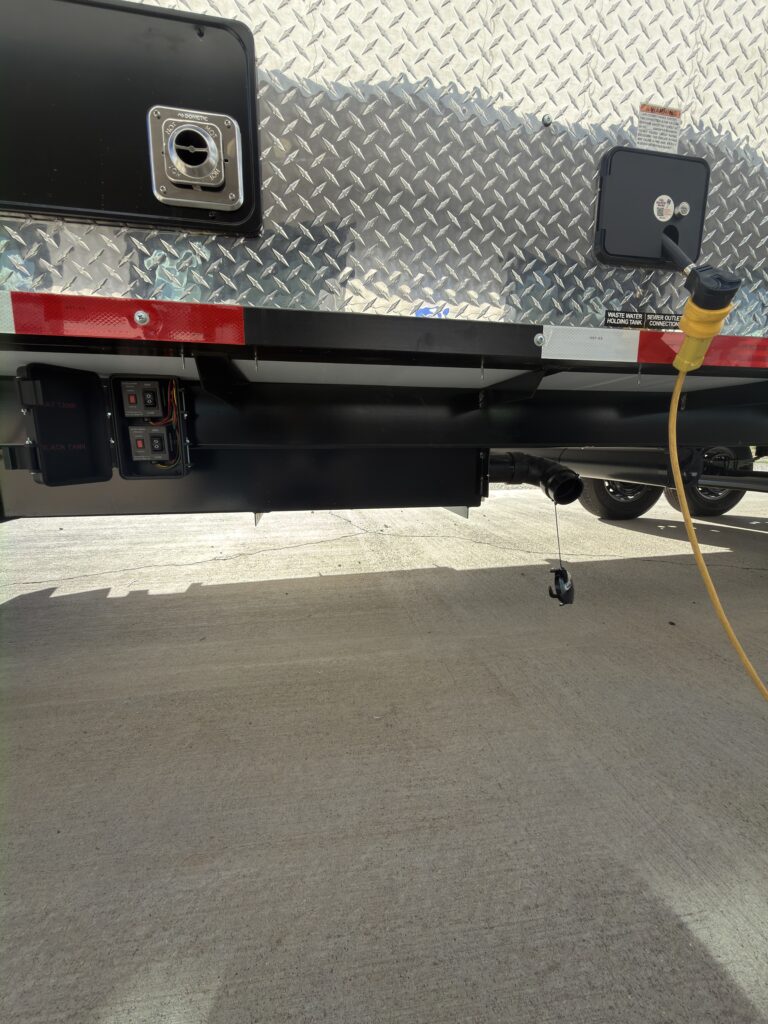 Image of the diamond-plate utility panel and rear bumper of Gail Camp #131.