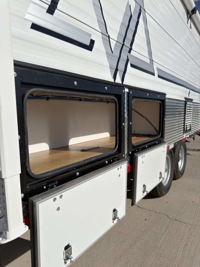 Image of the open passenger-side storage compartments of Gail Camp #131.