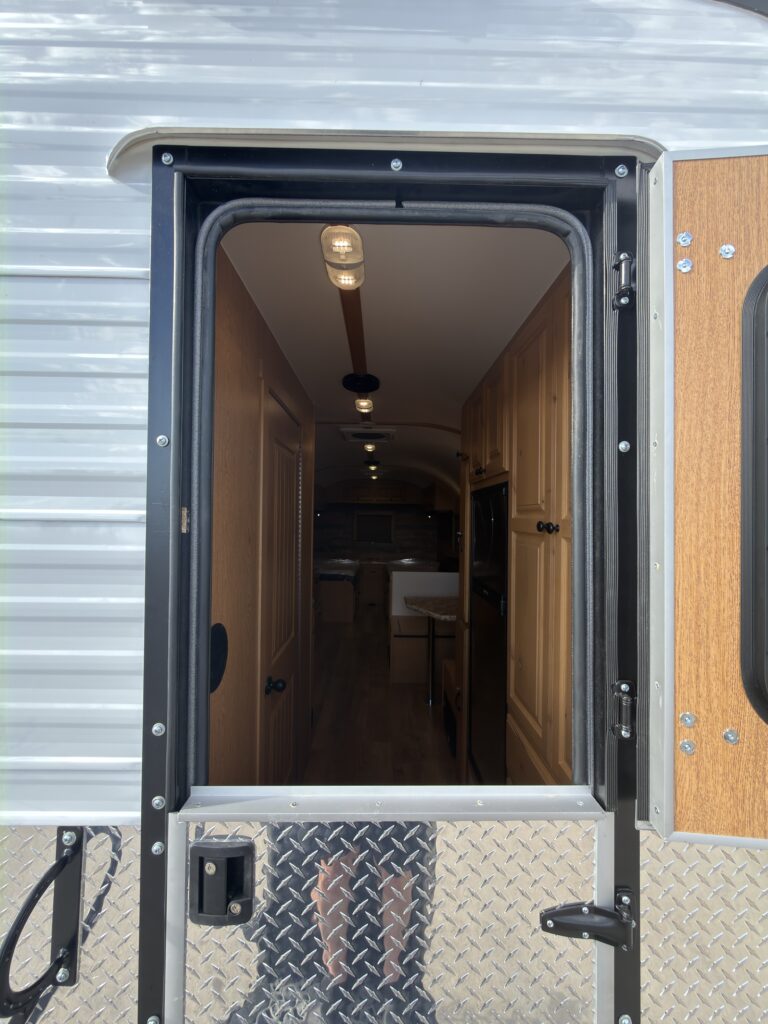 Image of the open entry door and interior hallway of Gail Camp #131.