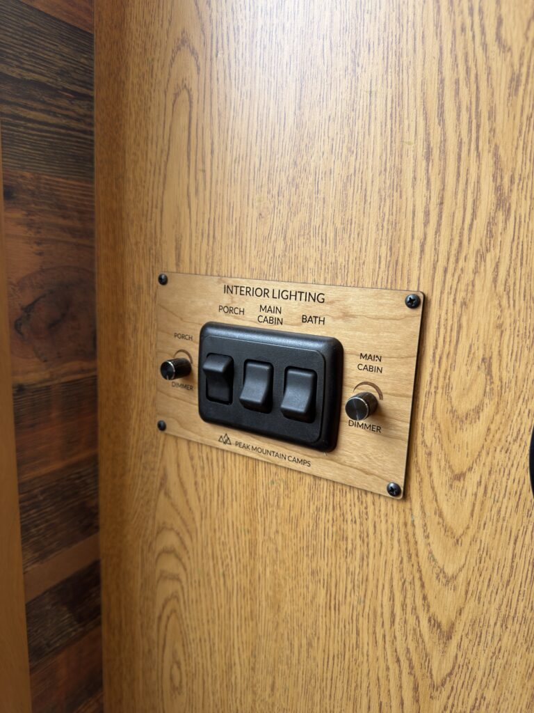 Image of the entry wall light switches and dimmers of Gail Camp #131.