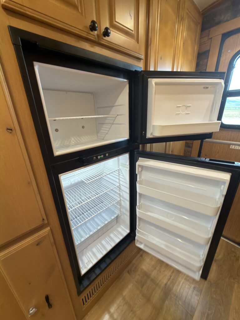 Image of the open refrigerator and freezer of Gail Camp #131.