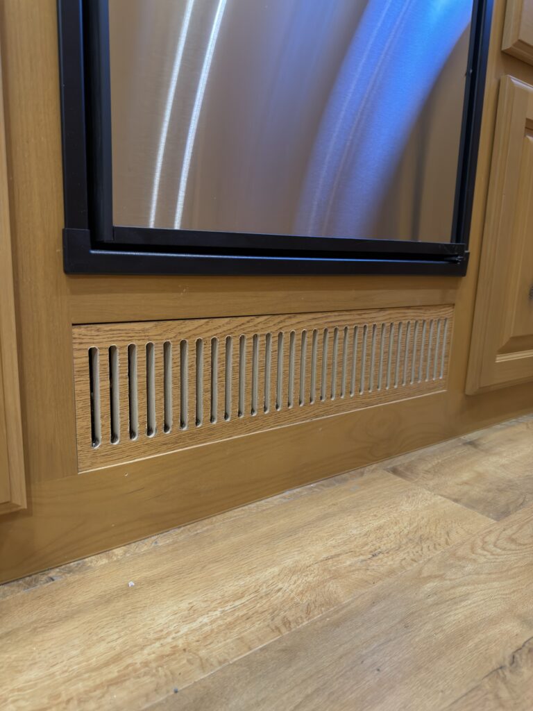 Image of the furnace vent below the refrigerator of Gail Camp #131.