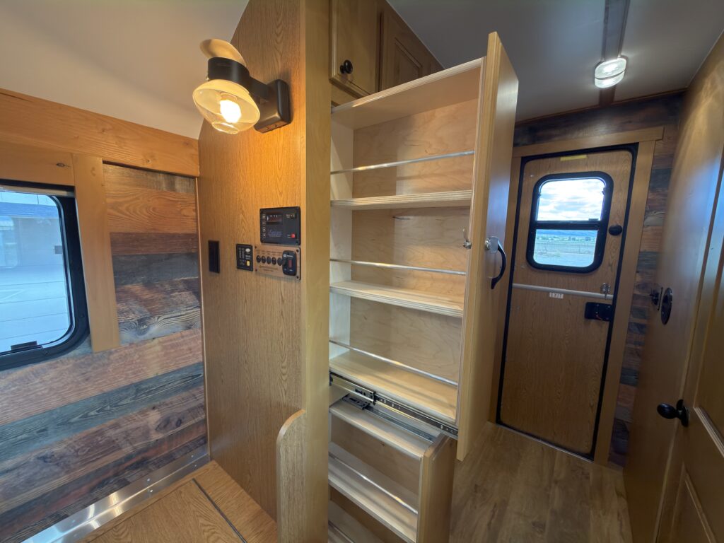 Image of the open slide-out pantries of Gail Camp #131.