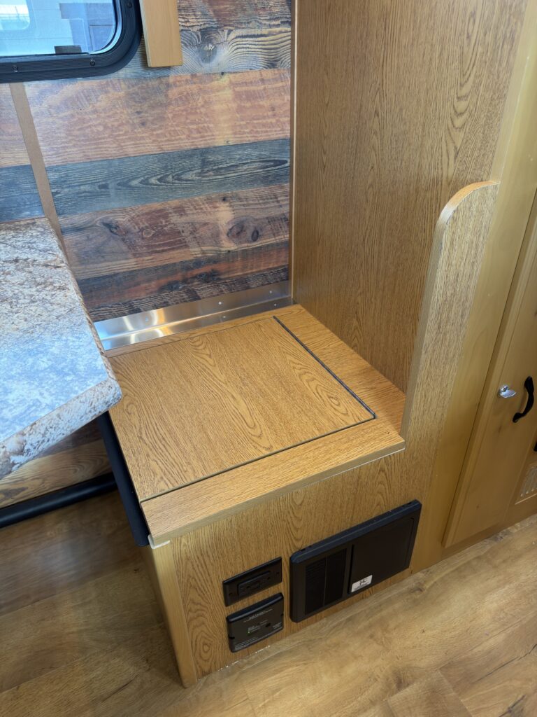 Image of the dinette bench and fuse box of Gail Camp #131.