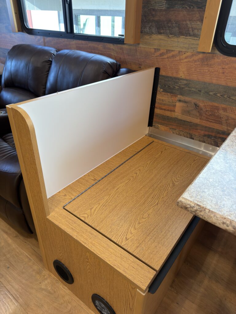Image of the dinette bench storage of Gail Camp #131.