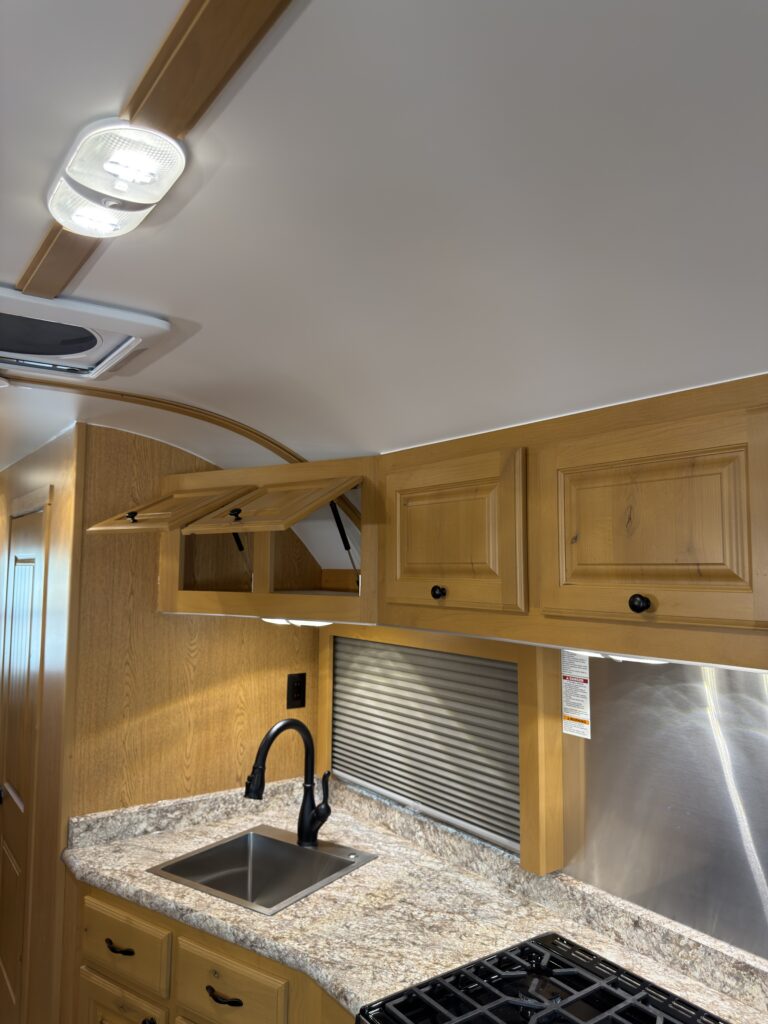 Image of the kitchen upper cabinets and cooktop of Gail Camp #131.
