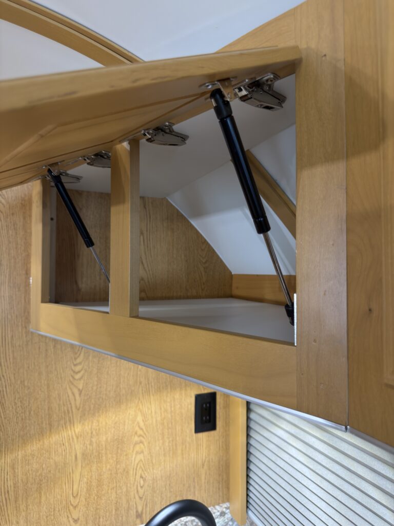 Image of the lift-up overhead cabinet of Gail Camp #131.