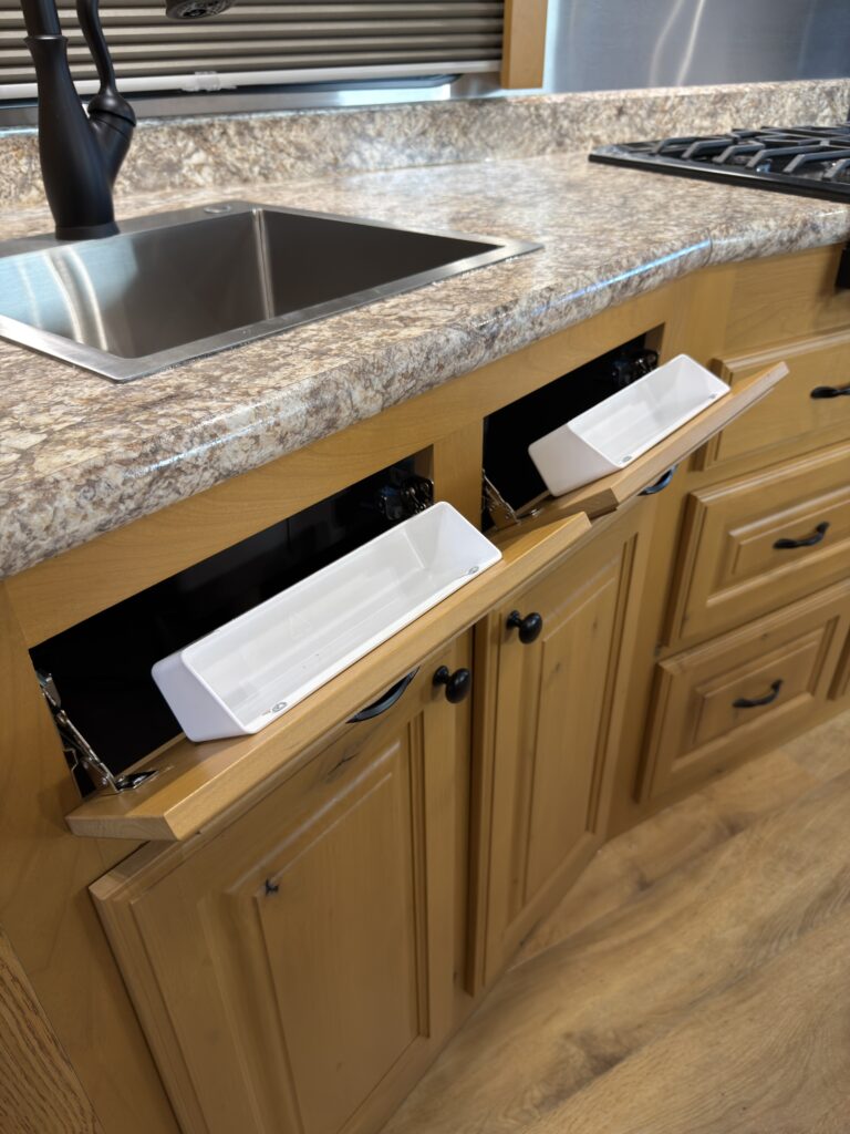 Image of the kitchen sink tip-out storage of Gail Camp #131.