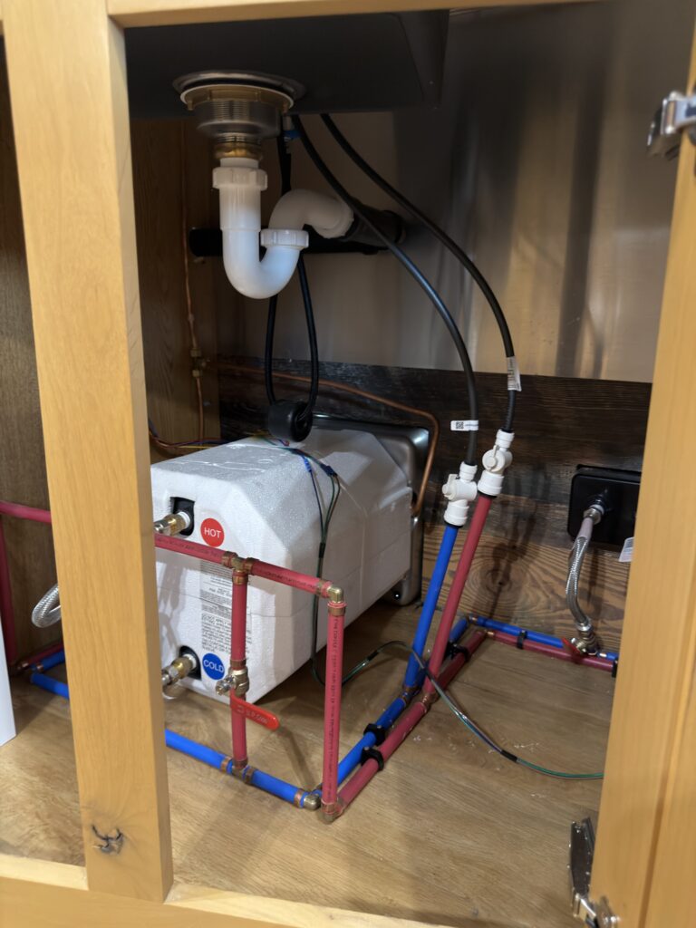 Image of the water-heater and plumbing compartment of Gail Camp #131.