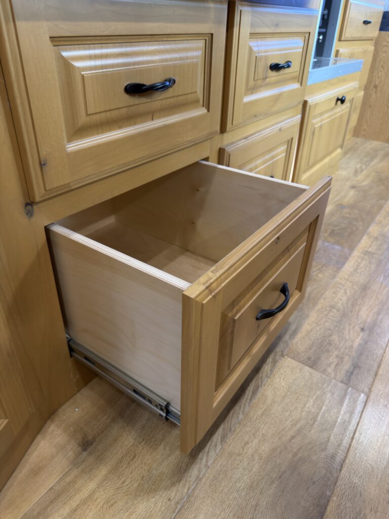 Image of the open lower kitchen drawer of Gail Camp #131.