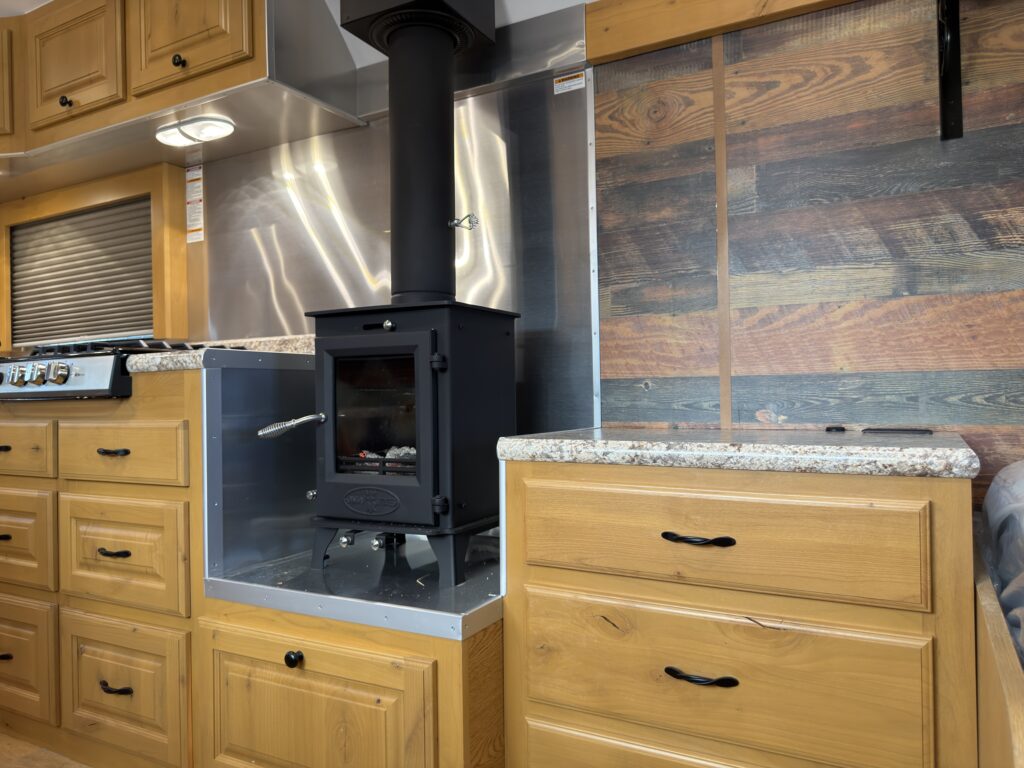 Image of the living area cabinetry and wood stove of Gail Camp #131.