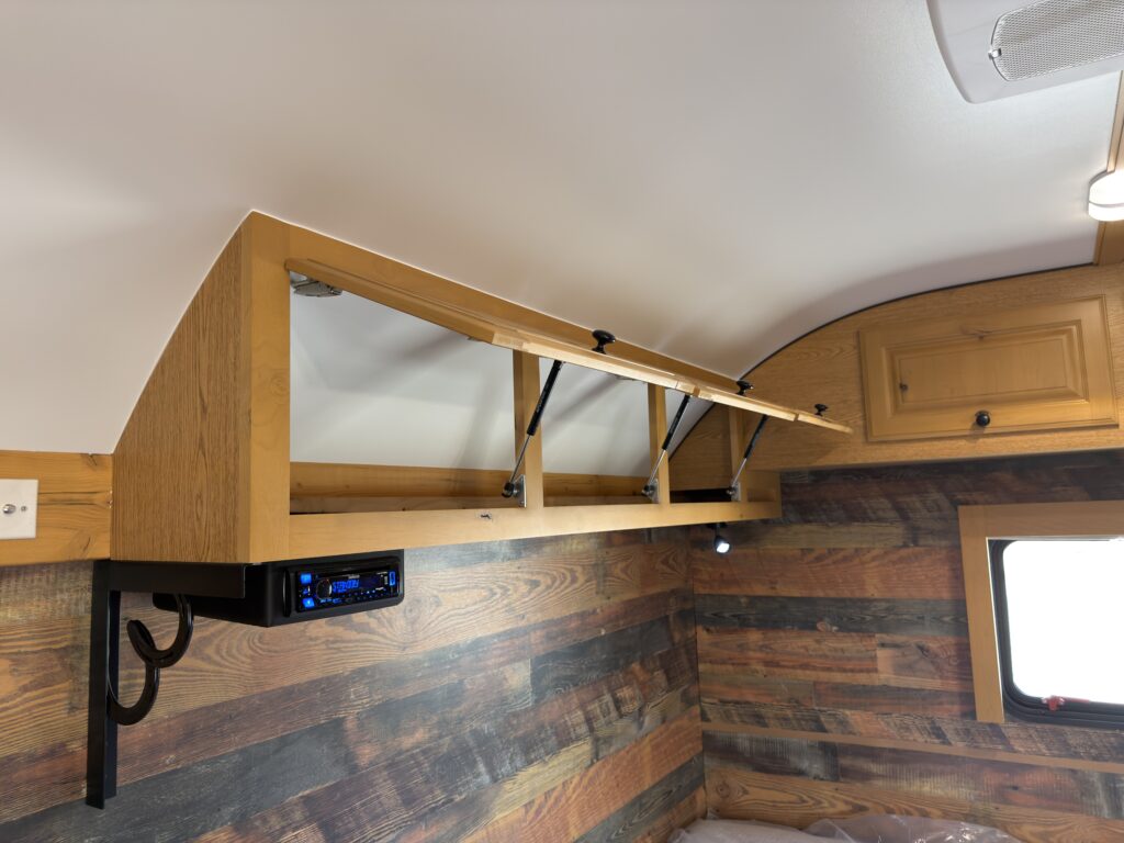 Image of the open bedroom overhead cabinets of Gail Camp #131.