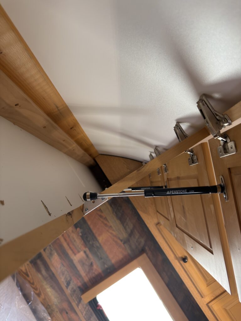 Image of the overhead cabinet lift hardware of Gail Camp #131.