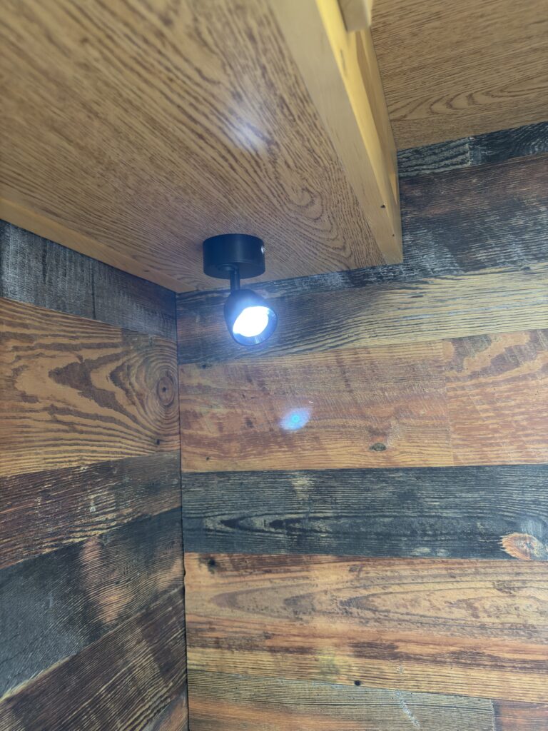 Image of the bedroom reading light illuminated of Gail Camp #131.