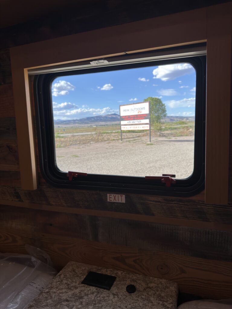 View of the exterior through the bedroom window of Gail Camp #131.