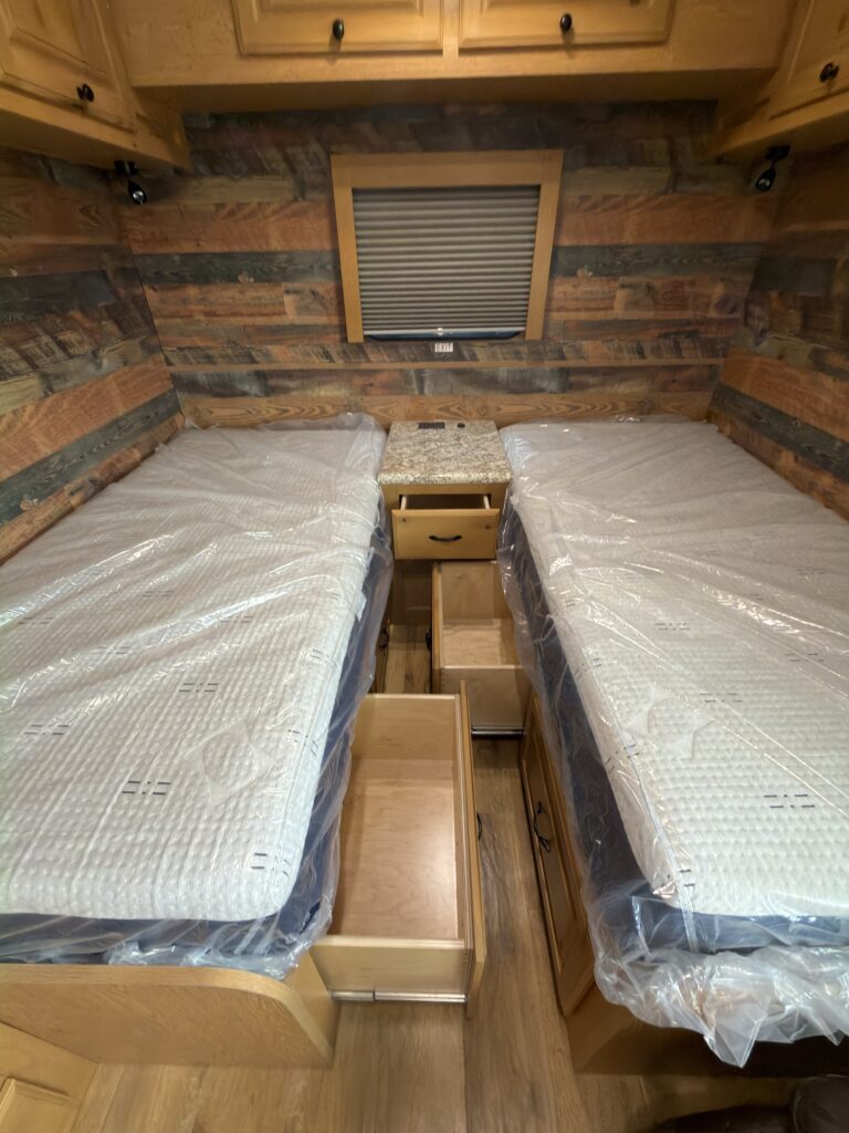 Image of the twin beds and center storage of Gail Camp #131.