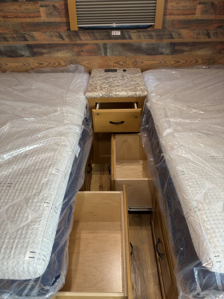 Image of the open center storage between twin beds of Gail Camp #131.