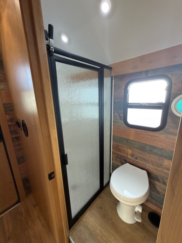 Image of the bathroom toilet and shower enclosure of Gail Camp #131.