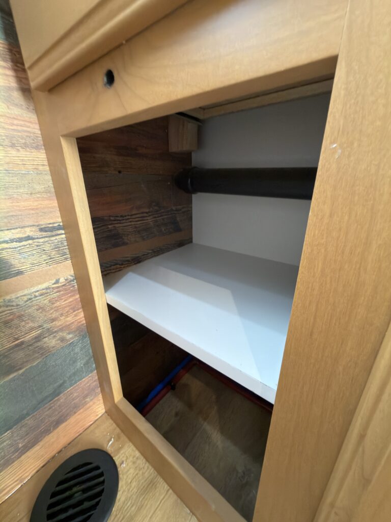Image of the open bathroom storage of Gail Camp #131.