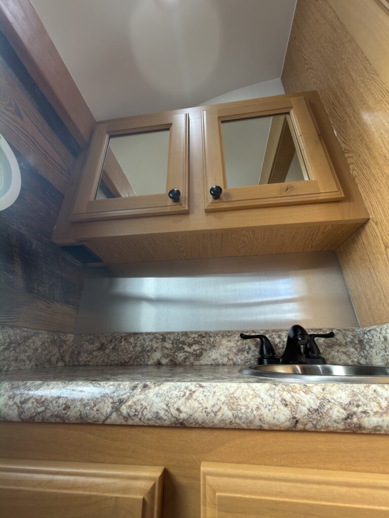 Image of the bathroom vanity and upper cabinets of Gail Camp #131.
