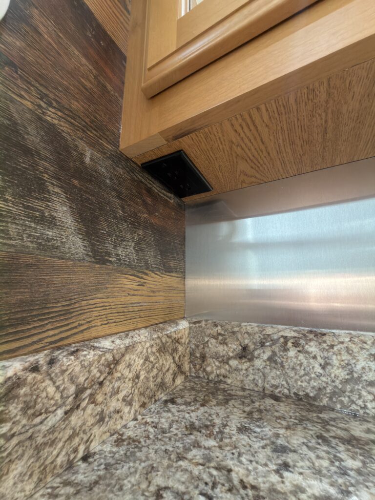 Image of the bathroom backsplash and wall outlet of Gail Camp #131.