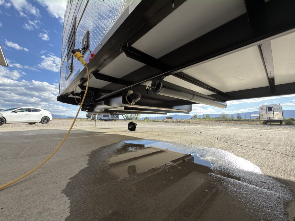 Image of the trailer underbody and drain line of Gail Camp #131.