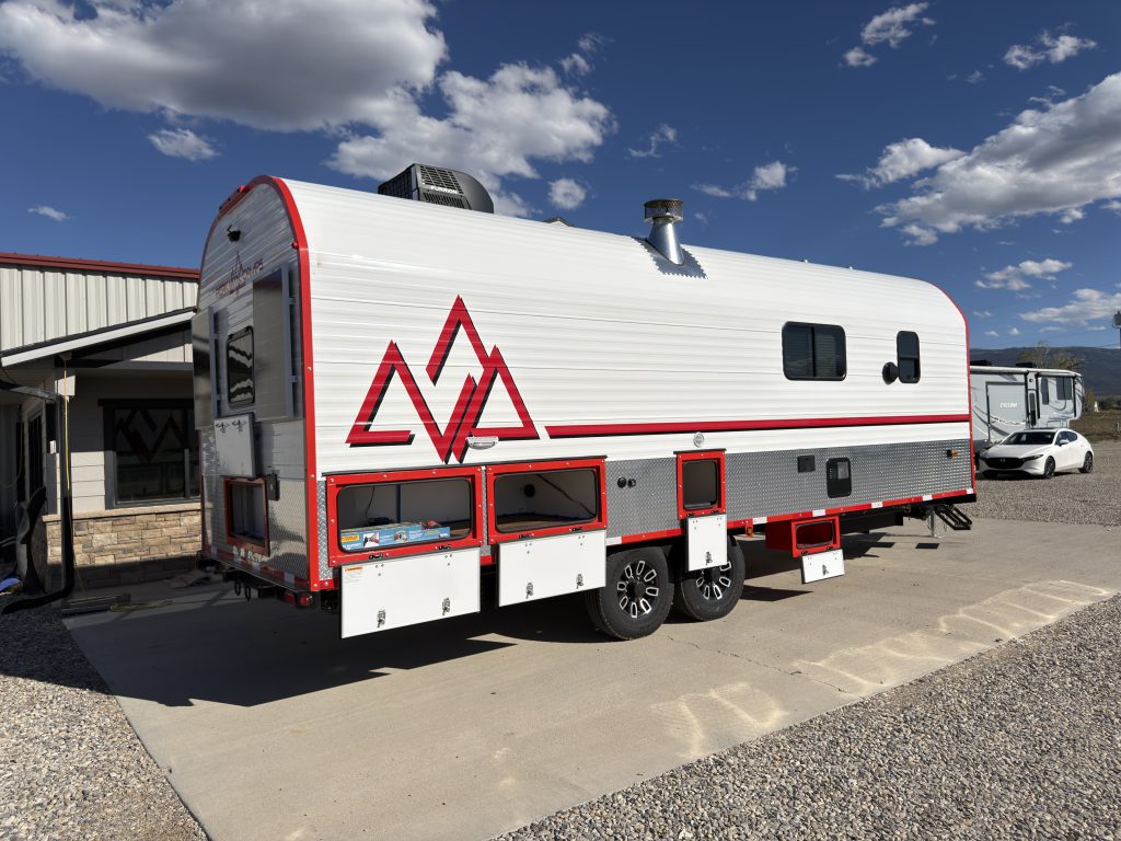 Road-Side Exterior with Storage Compartments Open on Nielsen Camp #133