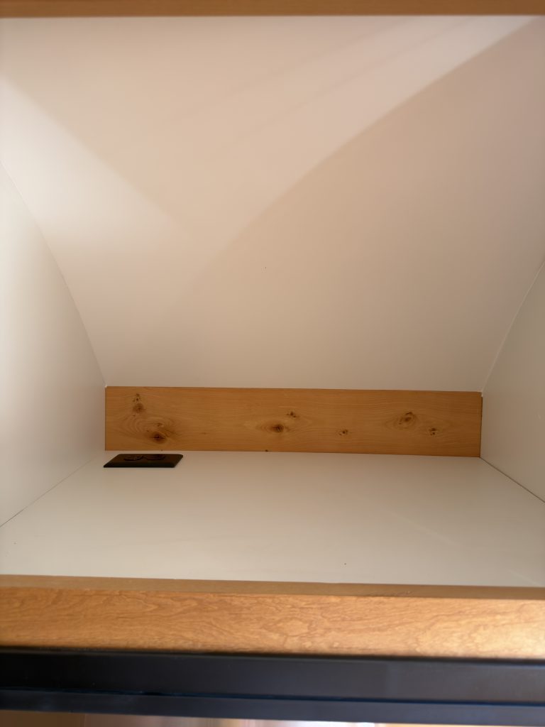 Open microwave cabinet in Nielsen Camp #133